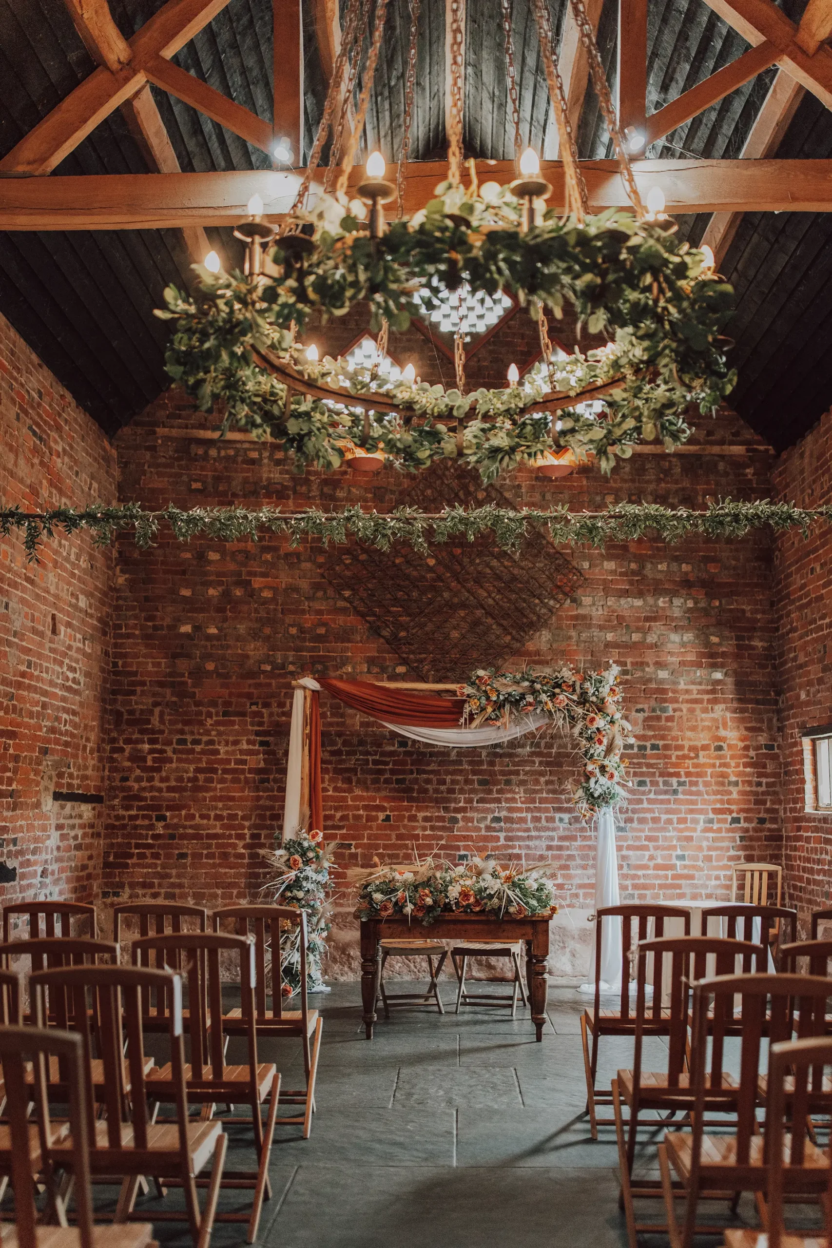 The Granary Barn wedding ceremony space dressed for an autumnal wedding at Curradine Barns