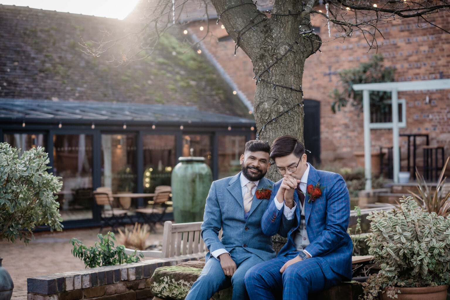 two grooms sit in front of Curradin Barns